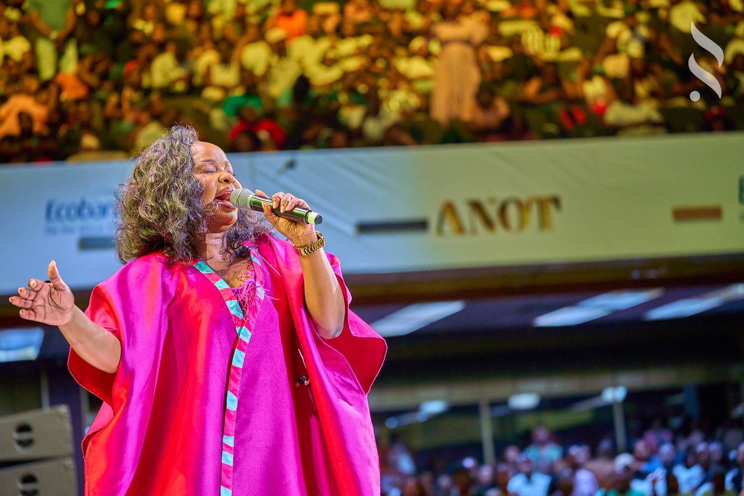 A singer in pink performing on stage, shot by Simply Art Creative